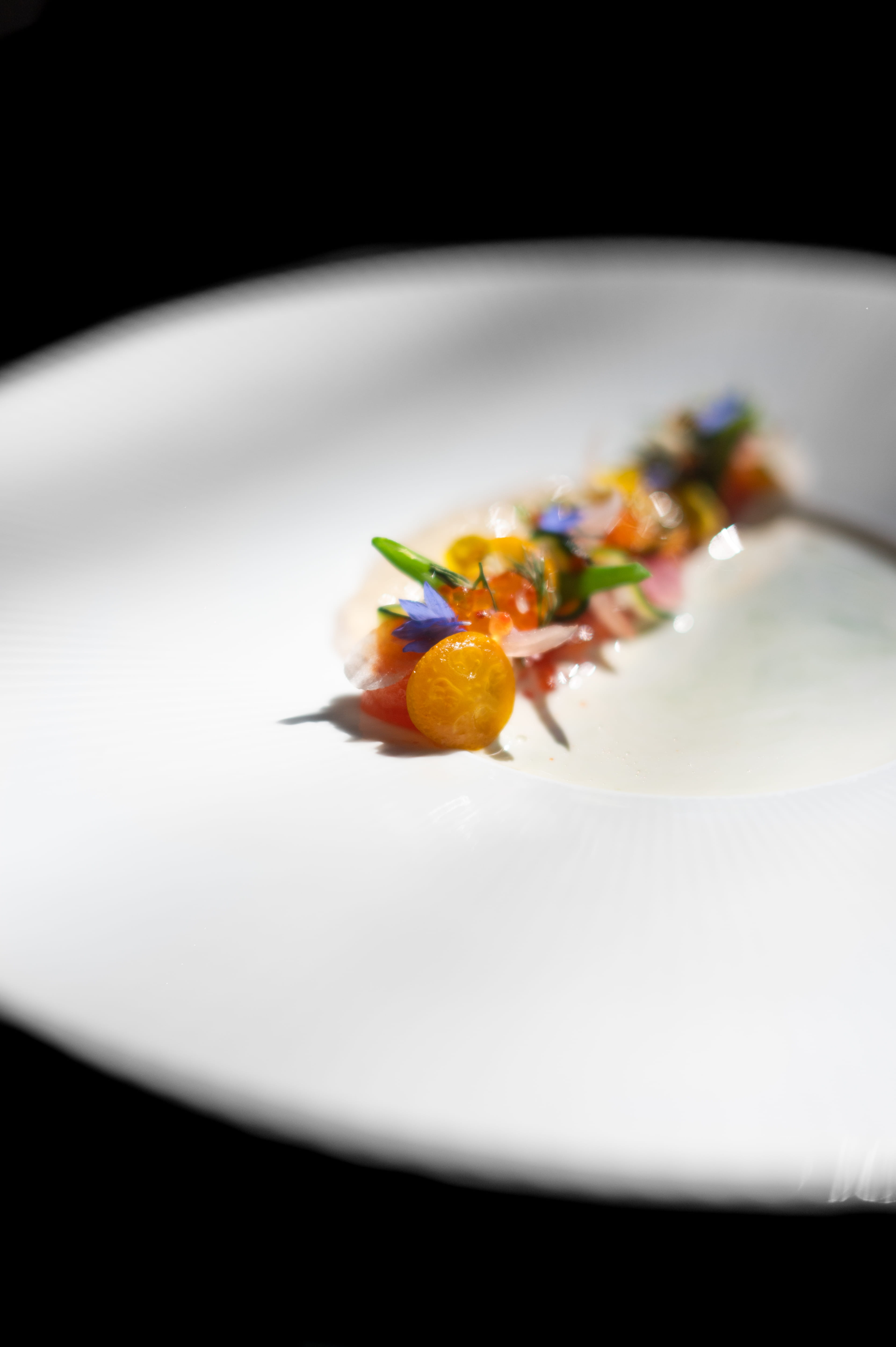 Upstate New York trout marinated in shio-koji and slowly confit at a low temperature, served with tomato water jelly and seasonal pickled vegetables